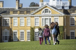 family walking in the gardens at Polesden Lacey, Surrey.